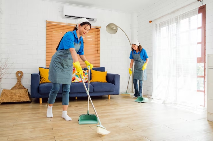 Move-in cleaning team deep cleaning empty rooms and polishing floors inside a newly prepared Southwest Florida home