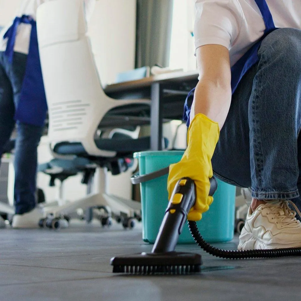 Cleaner wiping kitchen counters and mopping floors before family returns home for dinner
