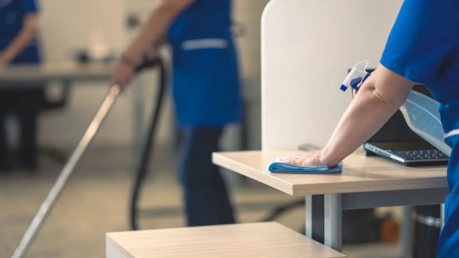 office cleaning team working in southwest florida, Office cleaner disinfecting high-touch surfaces with organized tools and methodical workflow, Skilled office cleaner inspecting corners, touchpoints, and flooring with careful attention