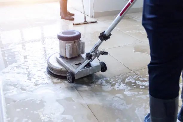 Commercial Office Cleaning Service in Fort Myers - FL wiping lobby glass doors before office opening