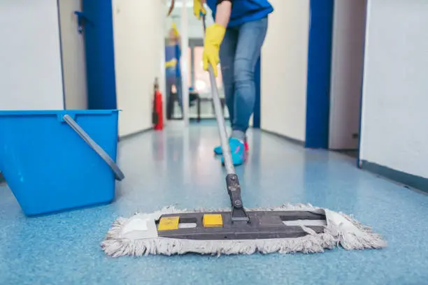 Commercial Office Cleaning Service staff sanitizing shared desks inside a Fort Myers - FL business suite